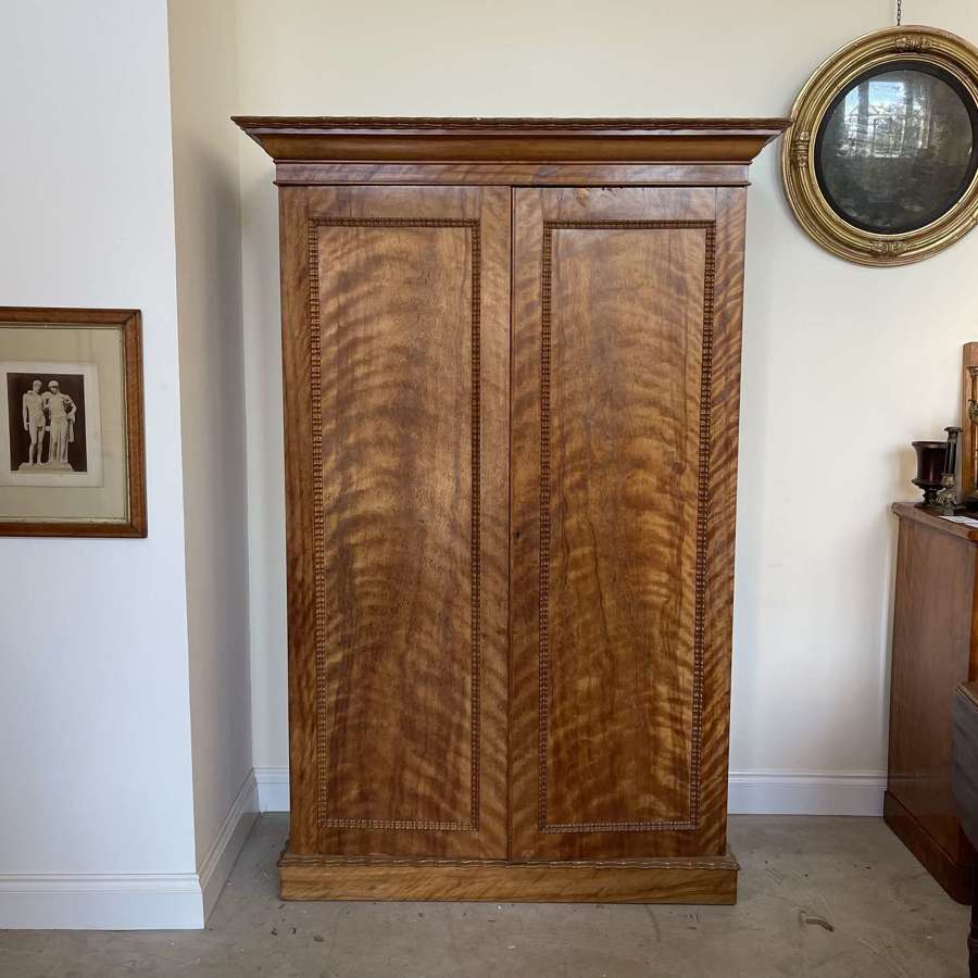 A 19th century satin birch wardrobe