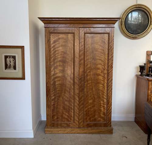 A 19th century satin birch wardrobe