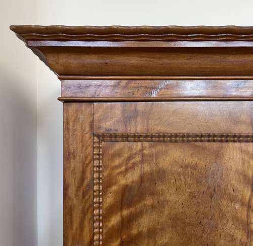 A 19th century satin birch wardrobe
