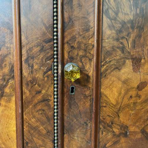 A 19th century simulated bur walnut wardrobe
