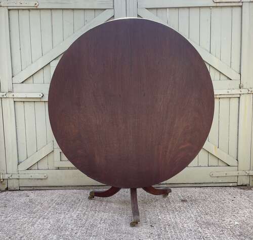 A plain 19th century tilt top table