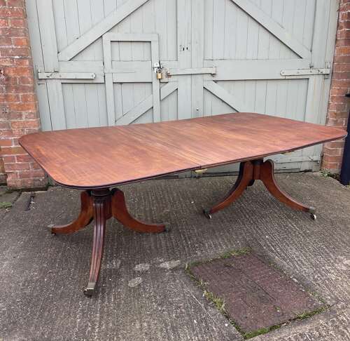 A 19th century twin pillar dining table