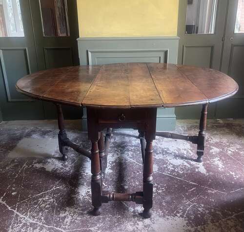 An 18th century yew wood gate leg table