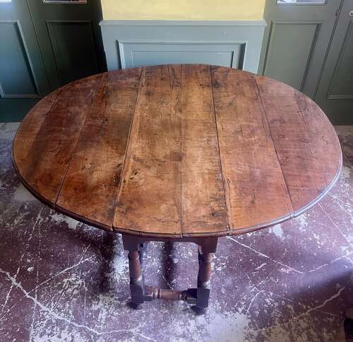 An 18th century yew wood gate leg table