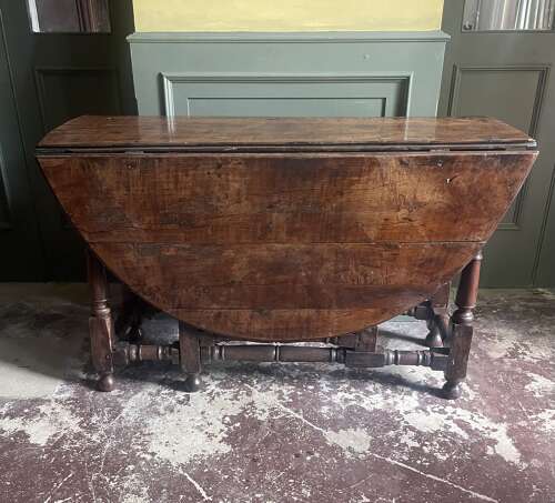 An 18th century yew wood gate leg table