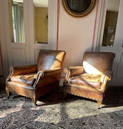 A pair of Edwardian leather club chairs