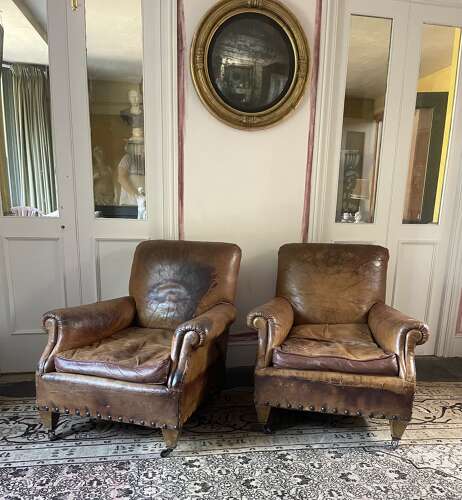 A pair of Edwardian leather club chairs