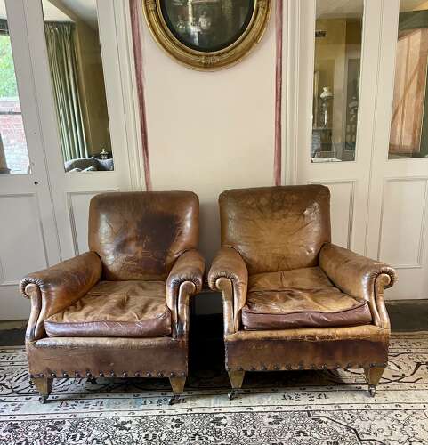 A pair of Edwardian leather club chairs