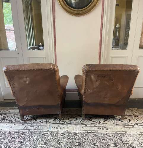 A pair of Edwardian leather club chairs