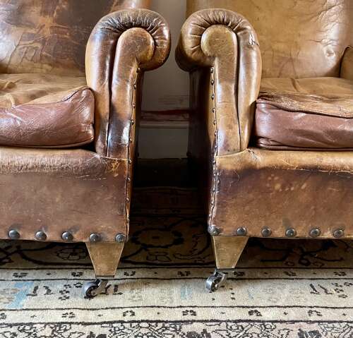 A pair of Edwardian leather club chairs
