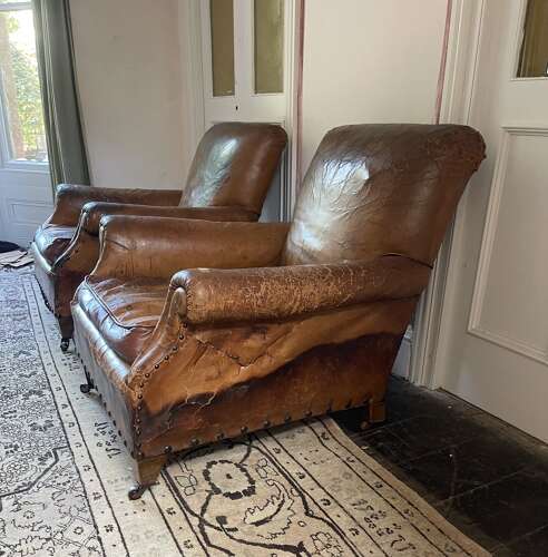 A pair of Edwardian leather club chairs