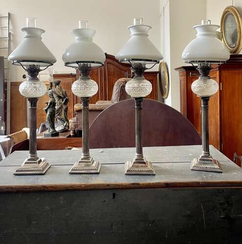 A set of four silver plate lamps by Hinks